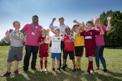 Celebrating summer at one of the hundreds of Summer Squad activities - this one was organised by The Way Youth Zone at Ashmore Park - are children with Councillor John Reynolds, Cabinet Member for Children and Young People, and Dave Harvey from The Way