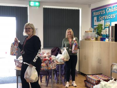 Loxdale Primary School teaching assistant Leanne Flitcroft and Assistant Headteacher Donna Mould  giving out food parcels