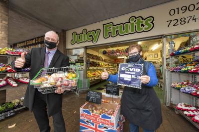 Councillor Steve Evans, cabinet member for city environment, with Linda Bellingham, at Juicy Fruits, Wednesfield High Street