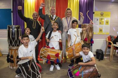 Back row ( L-R) Toni Jhalli, Director and teacher, Hit the Dhol Charity; Mayor of Wolverhampton Councillor Greg Brackenridge; Councillor Beverley Momenabadi, Cabinet Member for Children and Young People;  Front row: with drummers from the Hit the Dhol Charity 