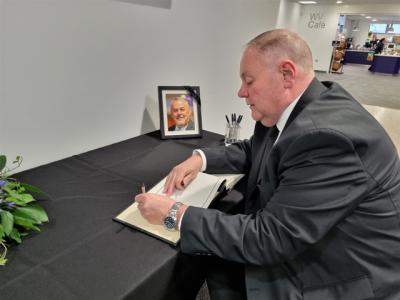 Deputy Leader of the City of Wolverhampton Council, Councillor Stephen Simkins, signs the book of condolence to remember Councillor Ian Brookfield