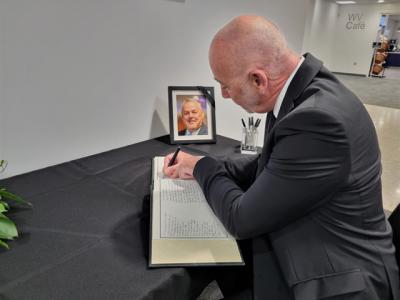 Chief Executive of the Council, Tim Johnson signs the book of condolence to remember Councillor Ian Brookfield