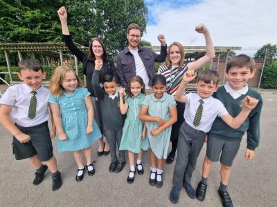Executive Headteacher Sarah Blower, Councillor Chris Burden, the City of Wolverhampton Council's Cabinet Member for Education, Skills and Work and Head of School Jemma Nash celebrate Christ Church CE Junior School’s Good Ofsted report with pupils