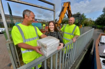Waste operative Stephen Startin (left) and site manager Dave Phillips with resident Rhiannon Thompson.  Photo credit: Express & Star