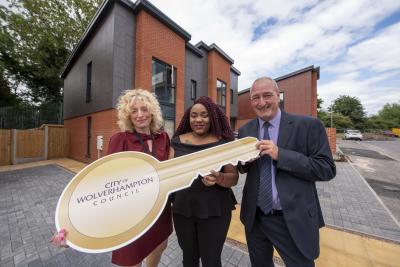 Tenant Yolanda Masiyiwa (centre) takes the key to her new Heath Town estate home from Wolverhampton Council Cabinet Member for City Housing, Cllr Steve Evans (right), and Wolverhampton Homes Head of Tenancies and Communities, Sophie Munn (left)