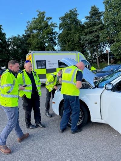 Officers from the DVSA inspect the seized limousine