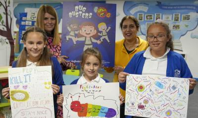 Elena Kalinowska, Nina Czubara and Cleo Dinham-Mears with their winning posters with Dovecotes Primary School headteacher Tracy Challenor and Councillor Jasbir Jaspal, the City of Wolverhampton Council's Cabinet Member for Adults and Wellbeing