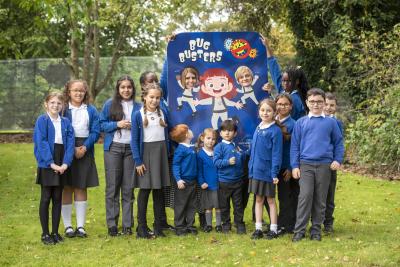 Pupils and staff at Dovecotes Primary School celebrate the arrival of the Bug Busters