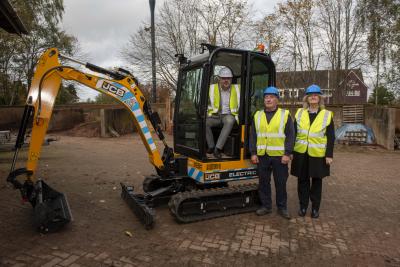 Councillor Craig Collingswood, cabinet member for environment and climate change, with the fully electric mini excavator alongside Mick Haynes and Catherine Averill from City of Wolverhampton Council