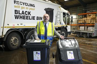 Councillor Craig Collingswood, cabinet member for city environment and climate change at City of Wolverhampton Council, with the new bin stickers to help residents recycle