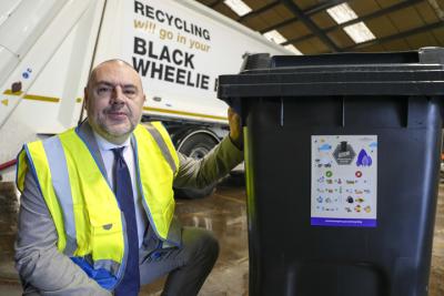 Councillor Craig Collingswood, cabinet member for city environment and climate change at City of Wolverhampton Council, with the new bin stickers to help residents recycle