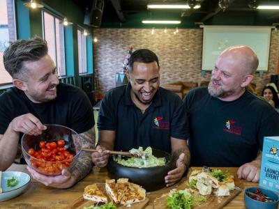 Mitch Lane and community chefs Prince and Simon with some of their delicious food at the event