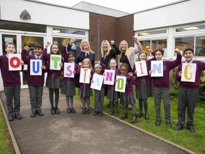 Celebrating St Bartholomew’s Church of England Primary School's outstanding report are pupils with, left to right, Katy Kent, CEO of St Bartholomew’s CE Multi Academy Trust, Rachael Kilmister, Headteacher, and Steph Banks, Deputy Headteacher