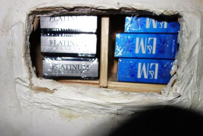 Some of the illicit cigarettes sniffed out by Cooper. The stash was found in a specially created sliding shelving unit hidden behind a wall