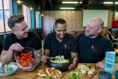 Mitch Lane and community chefs Prince and Simon with some of their delicious food at the event