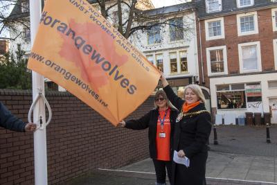 The Mayor Councillor Linda Leach raises the Orange Wolverhampton flag