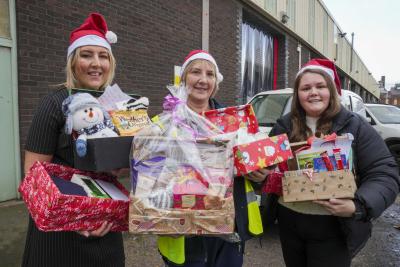 Laura Passmore, Director of Conduct at Thomas Telford UTC, Debbie Gait, from the City of Wolverhampton Council's Meals on Wheels service, and Shannon Hughes, Safeguarding Officer at Thomas Telford UTC, with some of the Christmas hampers