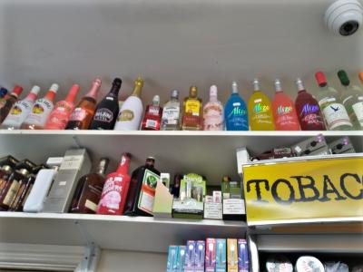 Some of the alcohol on shelving at Super Mahan during the seizures in June 2023 and of the seized alcohol in storage