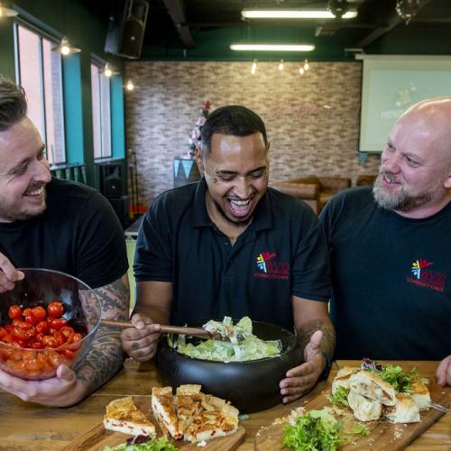 Mitch Lane and community chefs Prince and Simon with some of their delicious food at the event