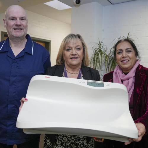 Darren Farmer, Health Visiting Team Leader at The Royal Wolverhampton NHS Trust, Elisabeth Whitehouse, Assistant Librarian, and Councillor Jasbir Jaspal, Cabinet Member for Adults and Wellbeing, with the baby weighing scales available at Graiseley Family Hub